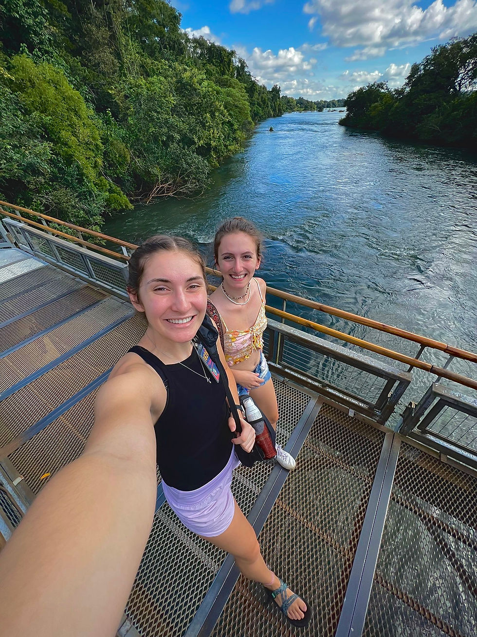 A picture of my friend and I walking across a bridge to see the waterfalls