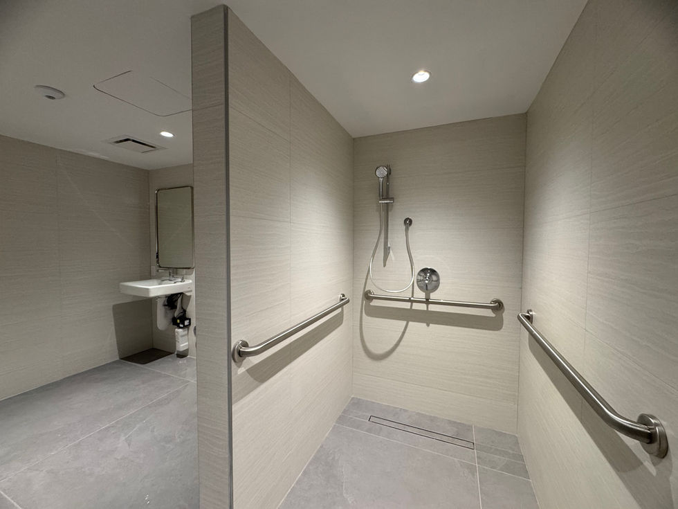 ADA bathroom with a walk in shower and a sink