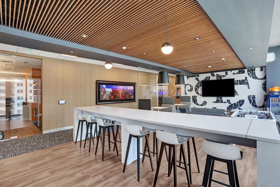 a room with a long white table and stools