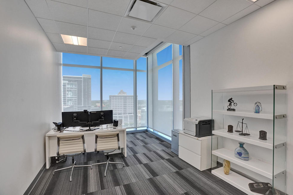 a small office with a desk and two computer monitors