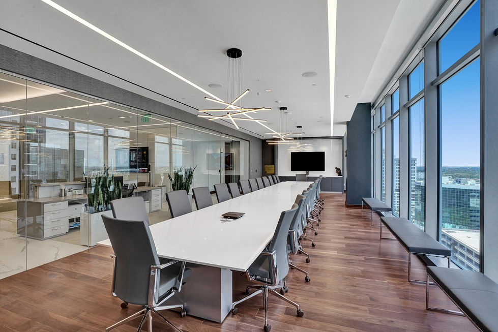 a conference room with a long white table and chairs