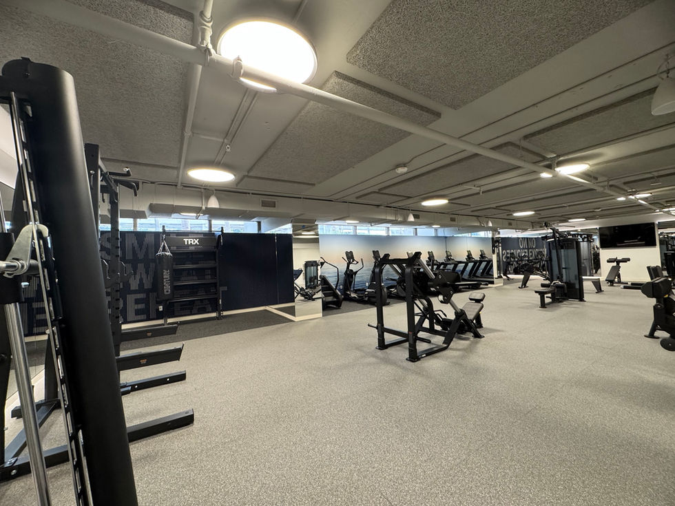 Lower lobby and tenant gym at One Biscayne Tower, Miami — modern interiors with fitness equipment.