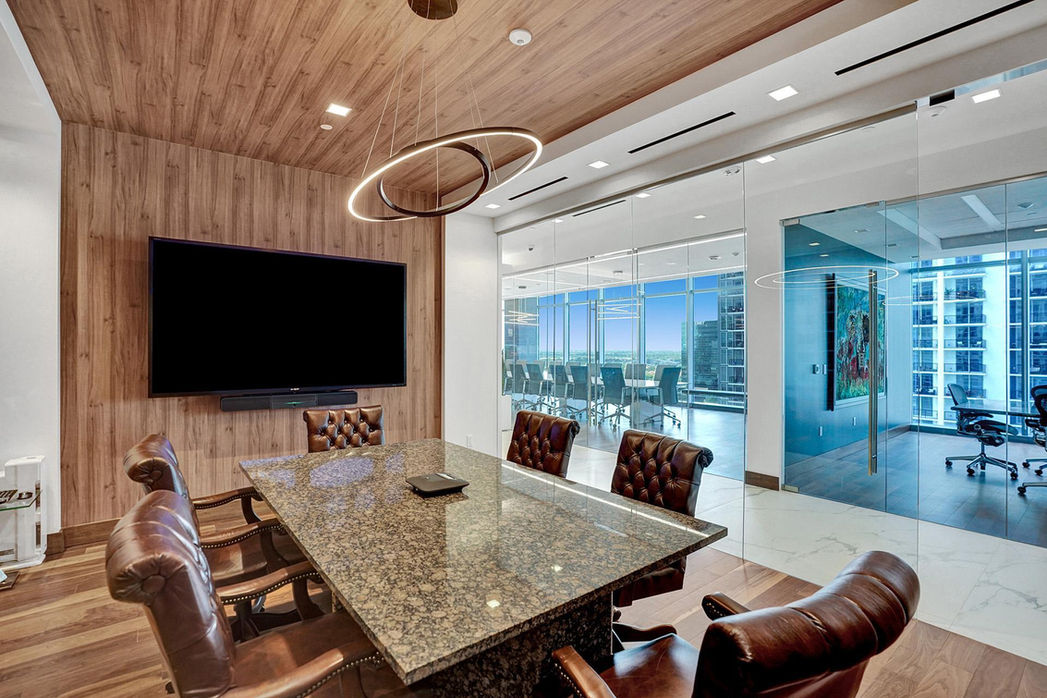 a conference room with a large flat screen tv on the wall