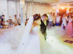 Bride and groom dancing during a wedding reception with professional Wedding DJ entertainment, dancing on the clouds, and intelligent lighting in Orlando, Florida.