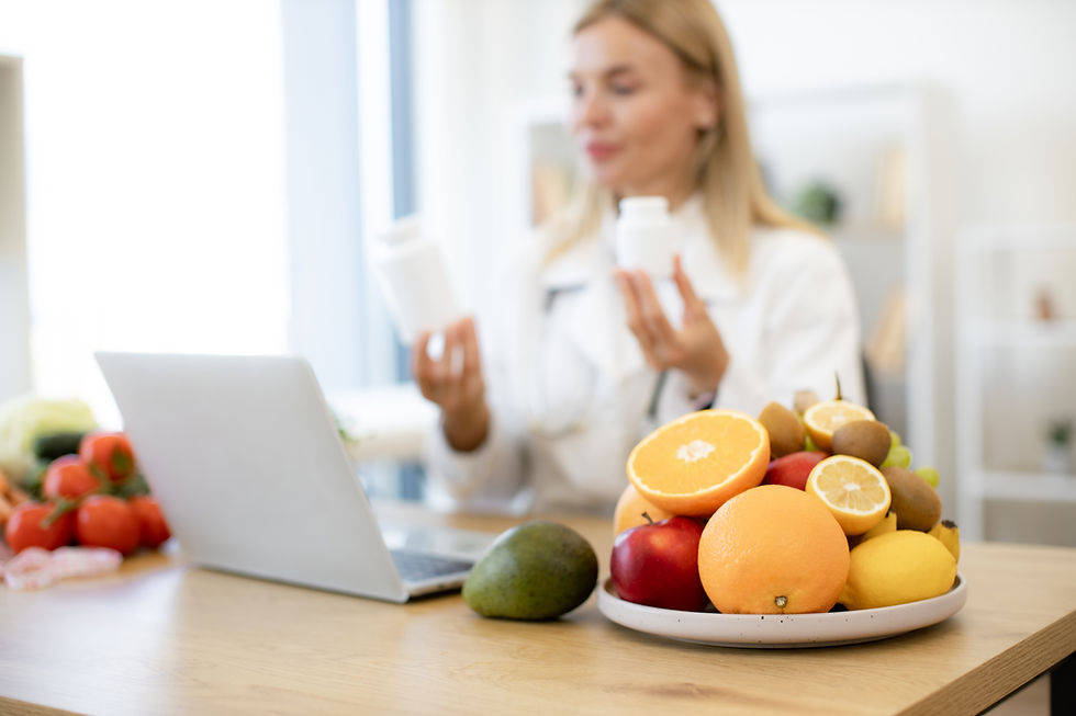 Nutritionist holding supplements beside fresh fruits — symbolizing personalized nutrition and gut health optimization at Zenovira Health