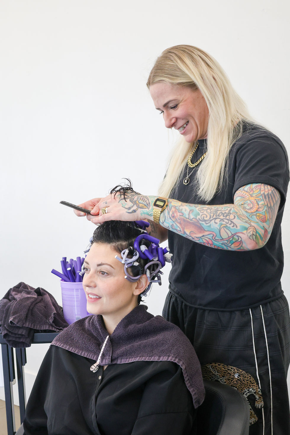 Stylist at Salon Diversions styling hair with rollers.
