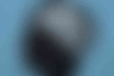 Silhouette of a head on blue background with tangled lines representing a brain, conveying confusion or complexity.