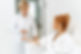 Side view portrait of attractive woman in white bathrobe sitting in armchair with pleasure