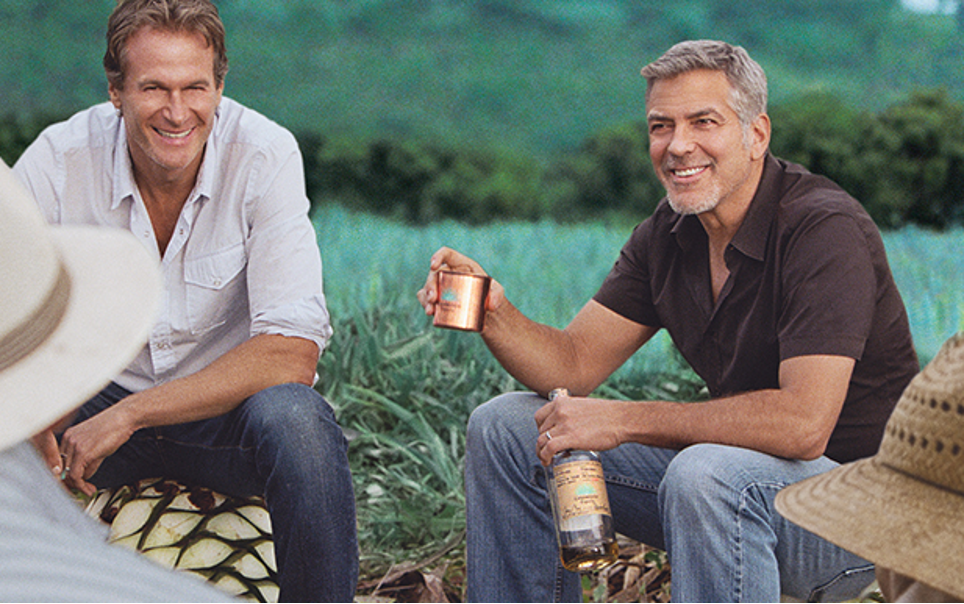 The image shows celebrity co-founder George Clooney holding a cup of casamigos tequila.