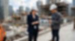 Architect and real estate professional reviewing AI-generated building visualizations on a tablet at a construction site, showing how visual tools support architecture design collaboration.