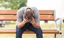 grief man head in hands