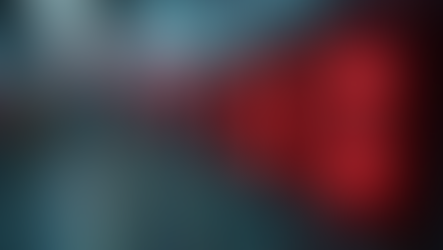 Red fire alarms glowing in a dim hallway, creating a sense of urgency. The word "FIRE" is visible. Blurred background.