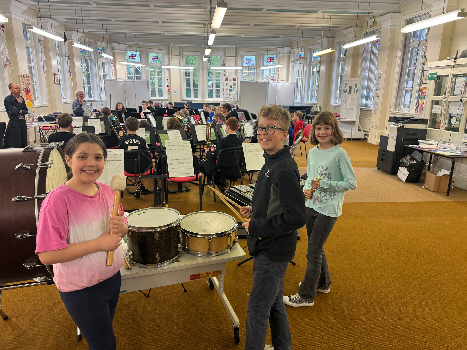 Three children with percussion instruments