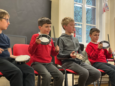 Four children with tambourines