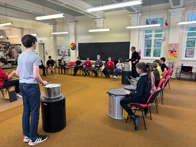 large group of children playing percussion instruments