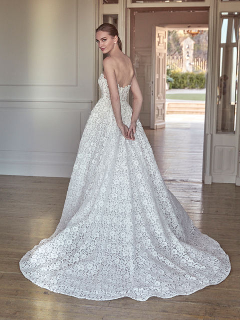 Crafted in guipure, this gown with a princess silhouette and strapless neckline is a statement of classic style with a contemporary flair.