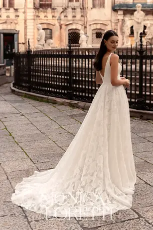 Elegant wedding gown featuring jacquard floral pattern, classic V neckline, wide belt, and an intricate skirt split. Perfect for timeless bridal style.