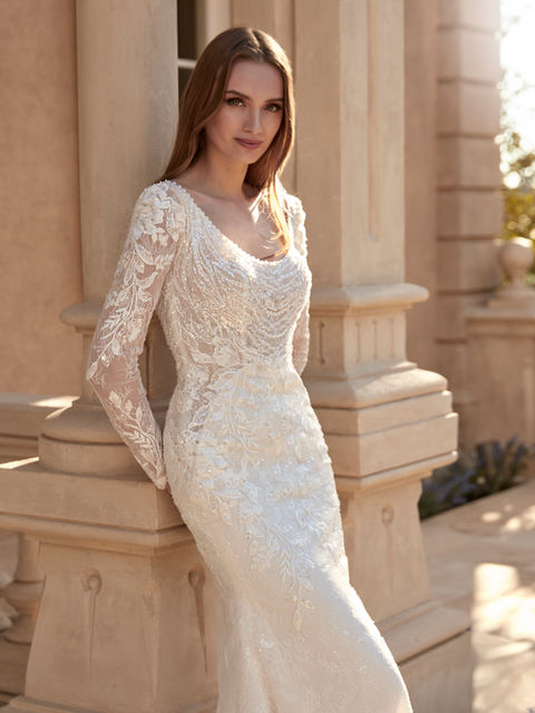 A romantic tulle gown with lace and beadwork, featuring a round neckline and open back. Long sleeves add a timeless touch of sophistication.