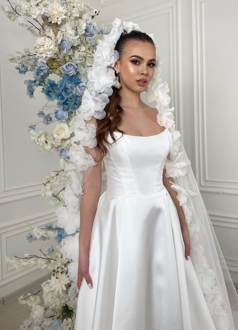 This sexy strapless style features a structured cat eye bodice and is made from soft satin. There is also a small train at the back of the dress for a touch of drama.