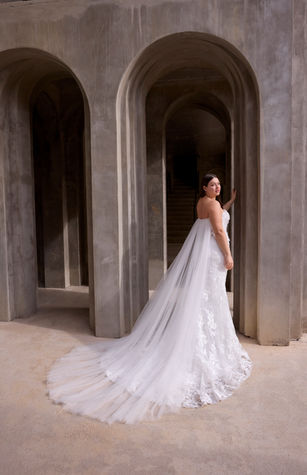Our Wome wedding dress is a strapless A-line gown that redefines modern romance with its sculpted sweetheart neckline and delicate 3D floral lace appliqué. The modified basque waist sculpts the silhouette, flowing effortlessly into a lace skirt that embodies timeless elegance, while detachable tulle watteau back adds a dramatic, ethereal layer.