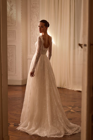 A glittering chantilly lace a line wedding dress with long sleeves, a sweetheart neckline and sensual semi sheer bodice.
