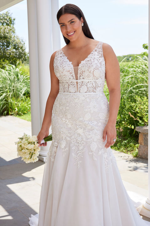 This mermaid wedding dress has a v-neckline, with a deep center plunge, open scoop back, and double banded waist to define your figure. The bodice is designed in crystal beaded embroidered lace, with a boho floral design, leading to an effortless tulle skirt that softly flares around you.