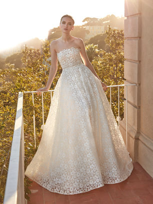 Crafted in guipure, this gown with a princess silhouette and strapless neckline is a statement of classic style with a contemporary flair.
