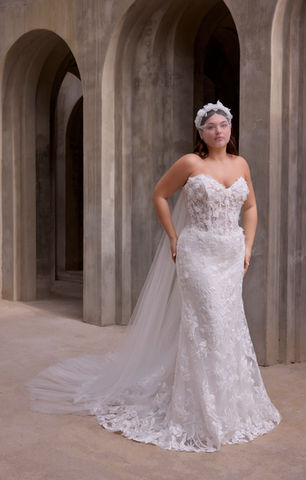 Our Wome wedding dress is a strapless A-line gown that redefines modern romance with its sculpted sweetheart neckline and delicate 3D floral lace appliqué. The modified basque waist sculpts the silhouette, flowing effortlessly into a lace skirt that embodies timeless elegance, while detachable tulle watteau back adds a dramatic, ethereal layer.