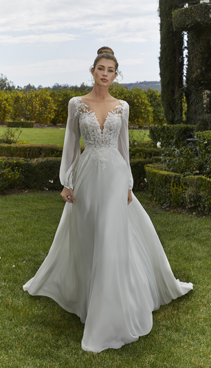 Crystal Beaded Venice Lace Appliqués on Net Over Chantilly Lace Bodice Meets the A-Line Chiffon Skirt with Chiffon Bishop Sleeves

IVORY/IVORY:
Ivory Lace on Ivory Chiffon Over Ivory Skirt Lining with Ivory Net Over Ivory Chantilly Lace Over Ivory Net Sheer Bodice and Ivory Net Yoke with Ivory Chiffon Sleeves, Accented with Crystal Clear Beading

IVORY/HONEY:
Ivory Lace on Ivory Chiffon Over Ivory Skirt Lining with Ivory Net Over Ivory Chantilly Lace Over Honey Net Sheer Bodice and Honey Net Yoke with Ivory Chiffon Sleeves, Accented with Crystal Clear Beading


Photographed in Ivory/Honey

Silhouette A-Line Neckline Illusion, V-Neck Colour Ivory/Honey, Ivory/Ivory Embellishment Appliques, Beading Sleeve Style Long Sleeves