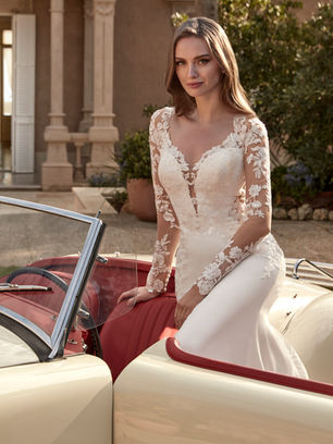 This crepe mermaid gown with tulle, lace, and beadwork combines a V-neckline with a figure-enhancing silhouette full of elegance and character.