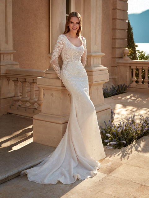 A romantic tulle gown with lace and beadwork, featuring a round neckline and open back. Long sleeves add a timeless touch of sophistication.
