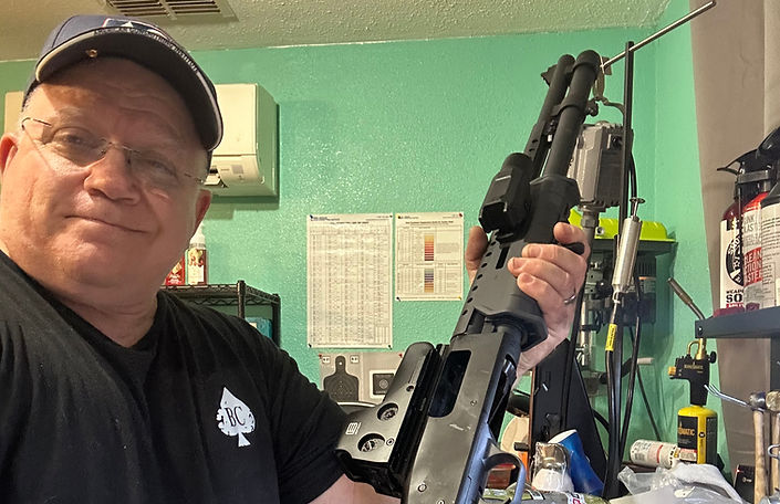 gunsmith Roland holding a shotgun