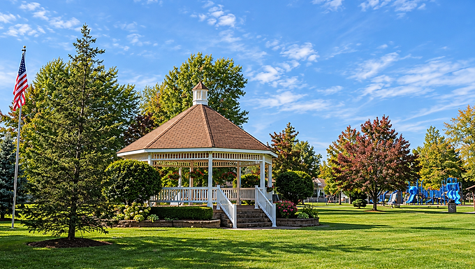 White gazebo surrounded by green lawns and mature trees at Mayfield Heights City Park in Mayfield Heights, Ohio