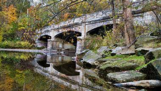 Scenic bridge crossing French Creek surrounded by wooded landscapes at French Creek Reservation in Sheffield Village, Ohio