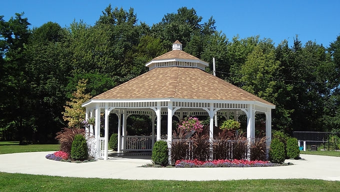 White gazebo surrounded by landscaped gardens and green space at Highland Heights Community Park in Highland Heights, Ohio