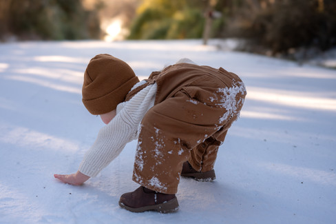 Little boy playing in the snow