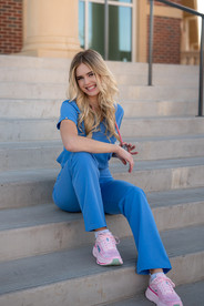 graduation nurse rn sitting on steps of texas womans university