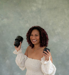 Photographer smiling and holding camera during a professional studio headshot session in Sherman, Texas.
