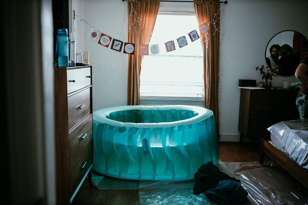 Home birth tub set up in bedroom for birth with midwife