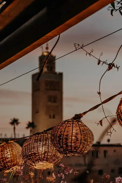 Sunset view over Marrakech with traditional lanterns at Kabana rooftop bar