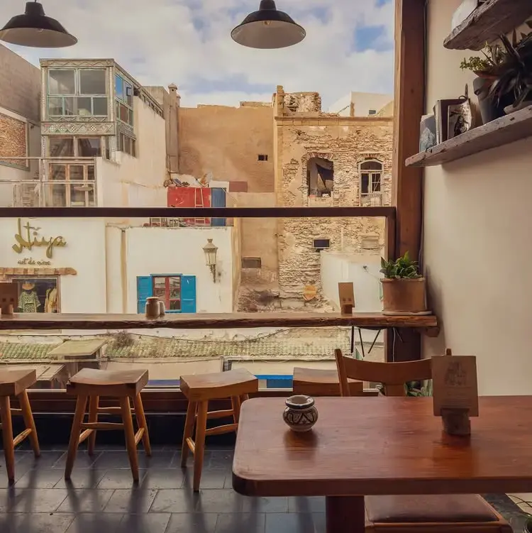 Second floor interior of Mandala in Essaouira overlooking historic buildings.