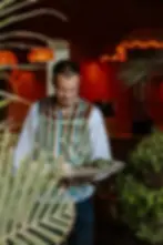 Villa Aaron waiter in striped traditional vest serving fresh dishes on a silver tray in a refined Marrakech restaurant setting