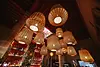 Warm lighting and rattan pendants above the bar at Dar Baba in Essaouira, ideal for private evening events and group gatherings.