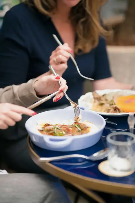 Guests sharing comfort food dishes at Villa Aaron brunch in casual setting