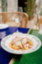 Gourmet seafood and radish dish served on a colorful tiled table at Villa Aaron, a classy brunch restaurant in Marrakech