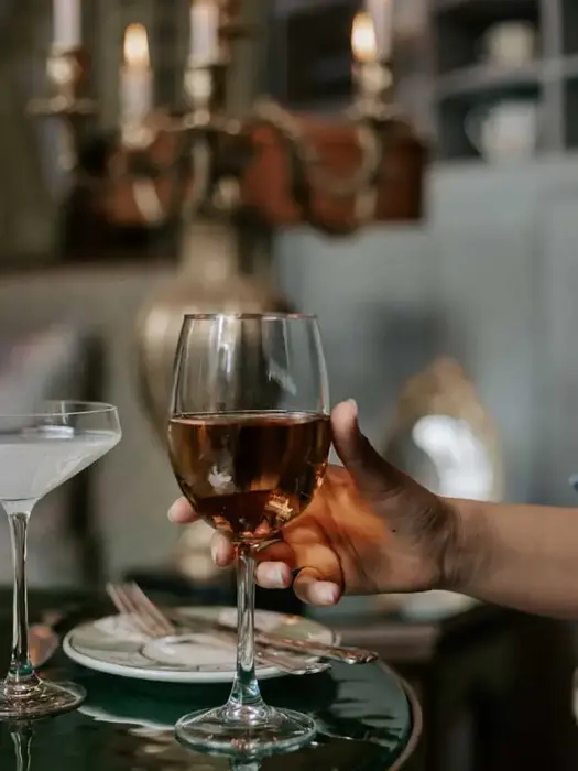 Close-up of a wine glass and cocktail served at Villa Aaron, showcasing refined table service in Marrakech