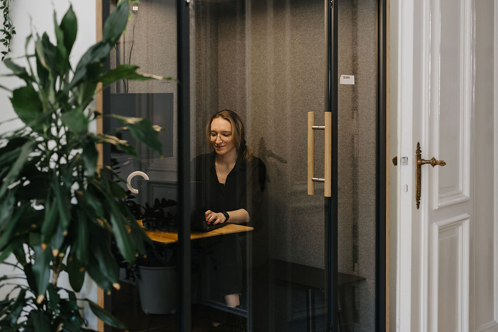 Gemma Analytics team member working in a quiet, soundproof booth on a laptop, focused and comfortable.