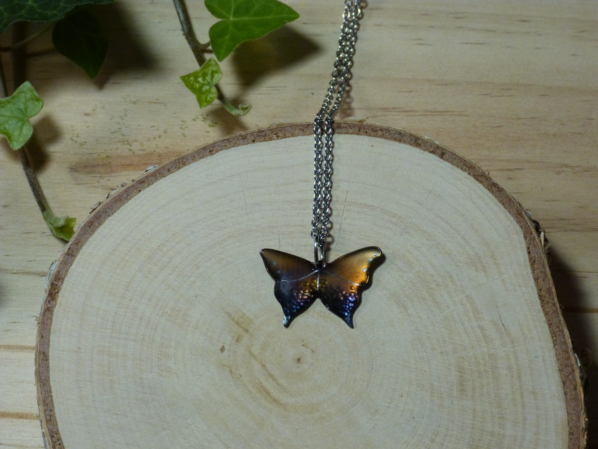 Pendentif petit papillon muticolore en acier bleui