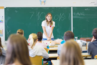 Instructor teaching first aid cardiopulmonary resuscitation course and use of automated ex