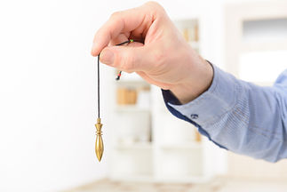 Hand Holding Pendulum